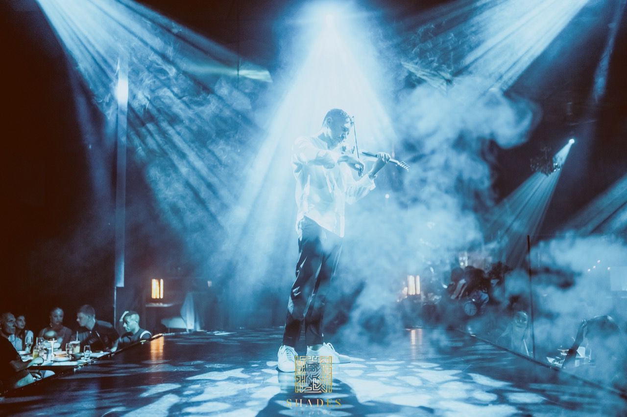 Nico performing live under blue stage lights